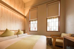 Letto o letti in una camera di HOTEL BEACON ONOMICHI