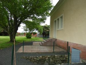 a fence in front of a building with a tree at Gîte de charme au Mans, 4 chambres, grand jardin, terrasse, Wi-Fi, proche commerces - FR-1-410-318 in Écommoy +11 photos