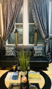 a living room with a black couch and a table at The Samone's in Atlanta