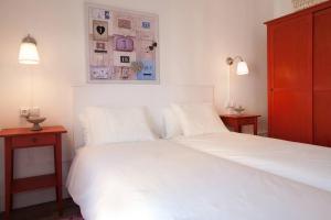 een slaapkamer met een wit bed met 2 nachtkastjes en 2 lampen bij Apt In 22 Close To The Beach in Barcelona