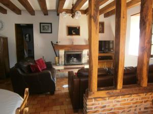 a living room with leather furniture and a fireplace at Gîte spacieux avec billard, cheminée & terrasse, près de la forêt de Bercé, Wi-Fi & activités nature - FR-1-410-337 in Thoiré-sur-Dinan