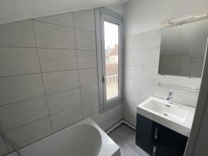 a bathroom with a sink and a toilet and a window at Studio central avec Wi-Fi proche des Thermes de La Roche-Posay - FR-1-541-82 in La Roche-Posay