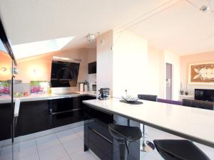 a kitchen with black cabinets and a white counter top at Appartement Évian-les-Bains, 2 pièces, 4 personnes - FR-1-498-69 in Évian-les-Bains