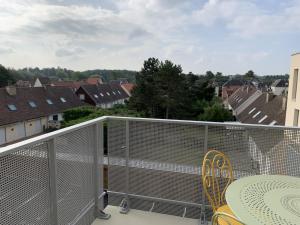 a balcony with a table and chairs and buildings at Appartement T2 Centre Ville avec Parking - Fort-Mahon-Plage - FR-1-482-94 in Fort-Mahon-Plage