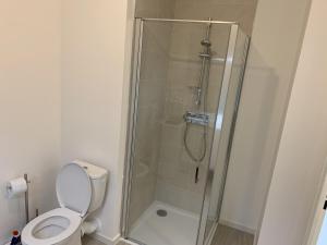 a bathroom with a glass shower with a toilet at Appartement T2 Centre Ville avec Parking - Fort-Mahon-Plage - FR-1-482-94 in Fort-Mahon-Plage