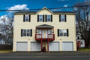 een wit huis met een rode brandtrap bij Cozy condo with yard and patio. Long-stay discount available in Fairfield