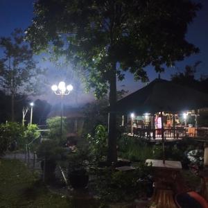 a night view of a restaurant with lights at Brown House Resort in Can Tho