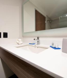 ein Bad mit einem Waschbecken und einem Spiegel in der Unterkunft Holiday Inn Express - Guadalajara Vallarta Poniente, an IHG Hotel in Guadalajara