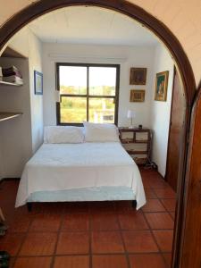 a bedroom with a bed and a window at Balcones del Cabito 008 in La Paloma