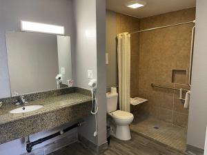 a bathroom with a sink and a toilet and a shower at El Segundo Inn in Hawthorne