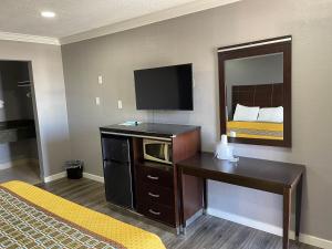 a hotel room with a television and a bed at El Segundo Inn in Hawthorne