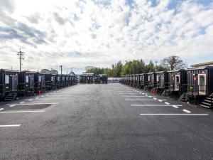 a parking lot with a row of train cars at HOTEL R9 The Yard Kikuchi in Kikuchi