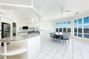 a kitchen and dining room with a table and chairs at The Pink Palace in Forster