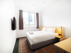 une chambre d'hôtel avec un lit et une table dans l'établissement YHA Sydney Harbour, à Sydney