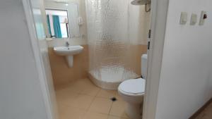 a bathroom with a shower and a toilet and a sink at Beach Pool and Spa Apartment in Marina Cape in Aheloy