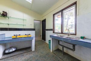 a large kitchen with a sink and a window at Bentong Wellness Resort Uphill 8Room 40Pax by Verano Homestay in Bentong