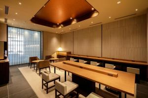 a conference room with tables and chairs and a large window at HOTEL VISCHIO TOYAMA in Toyama