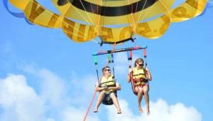 two people are riding on a hot air balloon at FLiXBEDS - Airport Hostel Book Now! Under New Management in Fort Lauderdale