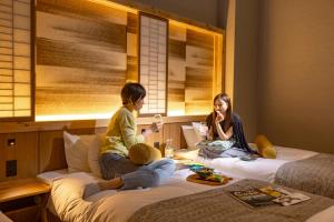Letto o letti in una camera di HOTEL BEACON ONOMICHI
