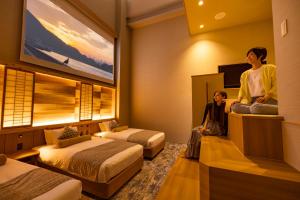 Letto o letti in una camera di HOTEL BEACON ONOMICHI
