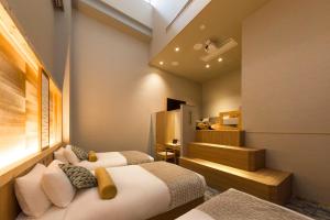 Letto o letti in una camera di HOTEL BEACON ONOMICHI