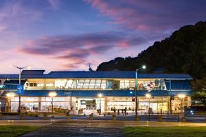 a building with lights in front of it at night at HOTEL BEACON ONOMICHI in Onomichi