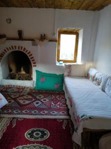 a bedroom with a bed and a fireplace in a room at Lübbey butik otel in Dolaylar