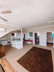 a large living room with a kitchen and a living room at Stella's Dromana Hotel in Dromana
