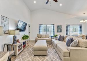 a living room with a couch and a table at Luxurious 6 Bedroom Home w/Garage Parking!Pets Too in Orem