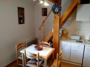 a kitchen with a table and a staircase at Appartement Mont-Dore, 2 pièces, 5 personnes - FR-1-415-113 in Le Mont-Dore