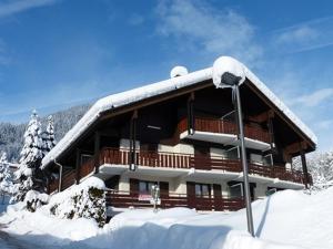 a building covered in snow with snow at Charmant Studio Cabine proche des Pistes, Village et Commerces - Location Idéale La Clusaz - FR-1-459-200 in La Clusaz