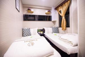 Katil atau katil-katil dalam bilik di Joyous Guest House