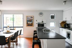 a kitchen and dining room with a counter and a table at Demure charm in Rye