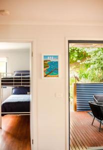 a bedroom with a bunk bed and a balcony at Demure charm in Rye