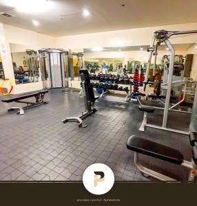 a gym with several treadmills and machines at FULLY FURNISHED STUDIO NEAR MOA in Manila