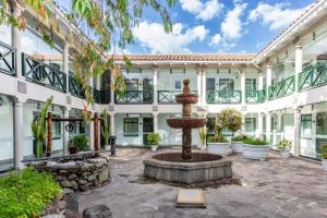 a courtyard with a fountain in front of a building at Casa Andina Premium Cusco in Cusco