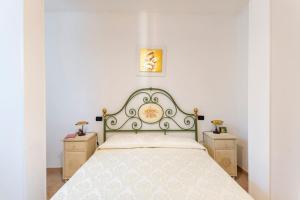 a bedroom with a large bed with two night stands at Appartamento indipendente ampia metratura in Santa Lucia