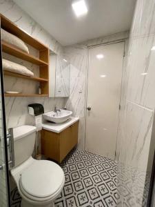 a bathroom with a toilet and a sink and a shower at Casa Lucilla in Davao City