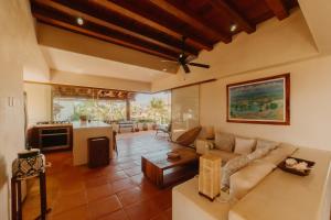 uma sala de estar com um sofá e uma mesa em Las Palmas Luxury Villas em Zihuatanejo