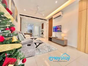 a living room with a christmas tree and a couch at Bali Residence Melaka By Heystay Management in Malacca