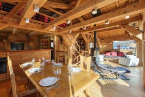 a dining room and living room of a log cabin at Chalet de l'Alpage - Happy Rentals in Les Houches