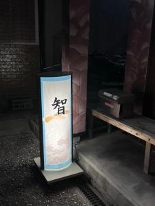 大阪市にある智TOMOのベンチの横に座る看板