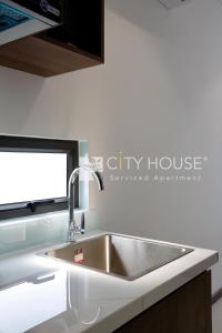 a stainless steel sink in a kitchen with a window at Cityhouse Villea in Ho Chi Minh City
