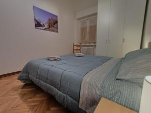 a bedroom with a bed and a wooden floor at MountainAosta - CIR 0062 in Aosta +16 photos
