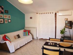 a living room with a white couch and a table at Family Friendly Apartments in Pula