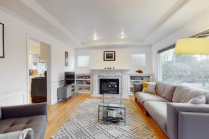 a living room with a couch and a fireplace at Woodlawn Escape in Seattle