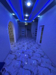an empty room with a blue ceiling and a marble floor at Guest house in Qabala in Gabala