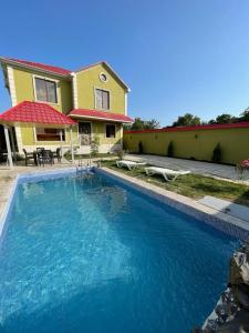 a house with a swimming pool in front of a house at Guest house in Qabala in Gabala