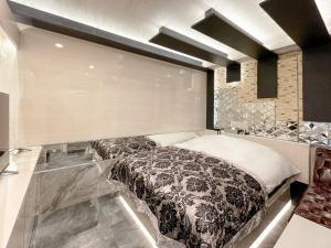 Postel nebo postele na pokoji v ubytování Hotel QUEEN ANNEX