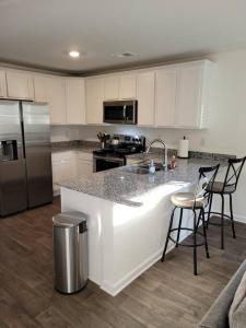 a kitchen with a white counter top and a refrigerator at SC 3745 New Townhouse Ft Jackson & USC in Columbia